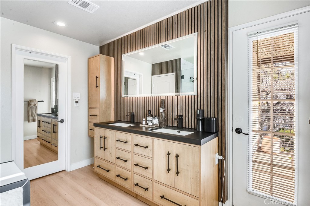 23301 Montecito Place Valencia, CA 91354 - Photo 21 of 41 a bathroom with a sink a mirror and a shower