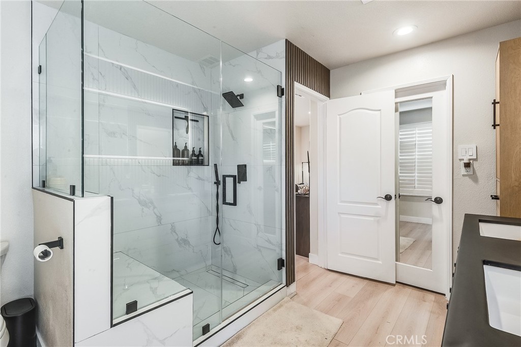 23301 Montecito Place Valencia, CA 91354 - Photo 22 of 41 a bathroom with a glass shower door