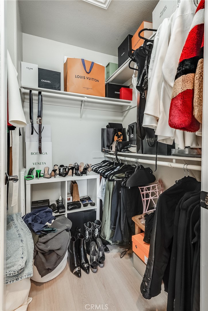 23301 Montecito Place Valencia, CA 91354 - Photo 23 of 41 a view of walk in closet with clothes and shoes