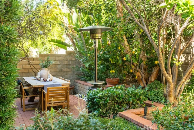 a backyard of a house with table and chairs