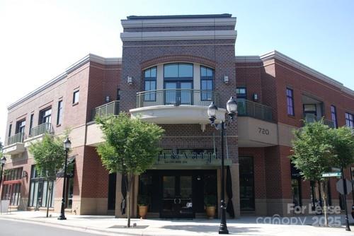 a front view of a building with a garden