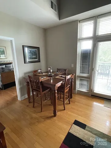 a view of a dining room with furniture and a large window