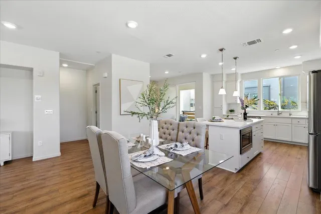 a view of a dining room with furniture and wooden floor