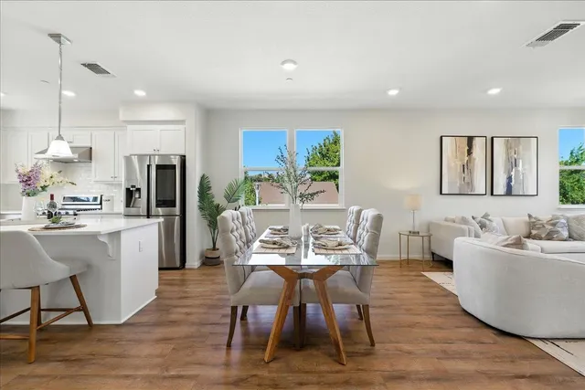 a kitchen with kitchen island white cabinets and stainless steel appliances