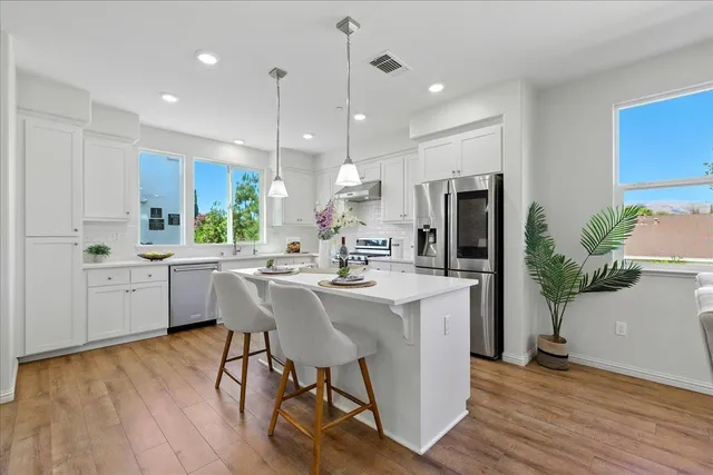 a open kitchen with sink table and chairs