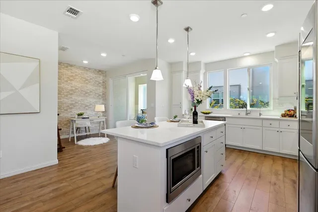 a large kitchen with a table and chairs
