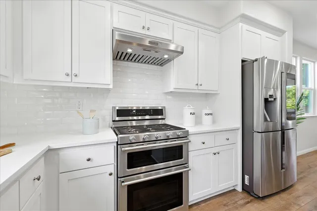 a kitchen with kitchen island a counter top space a sink appliances and cabinets