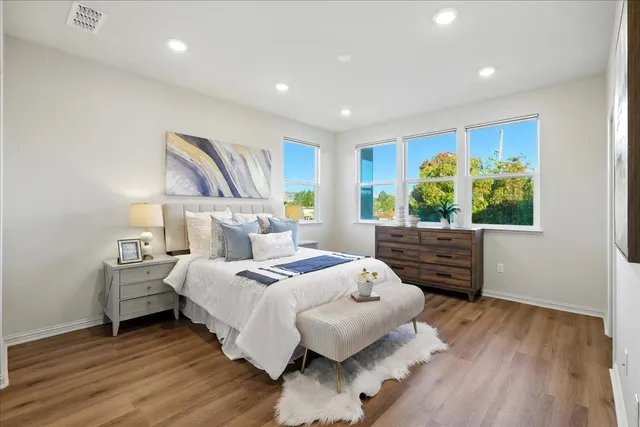 a bedroom with a bed and a potted plant