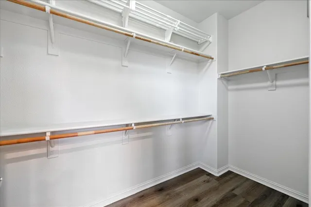 a bedroom with a bed and painting on the wall