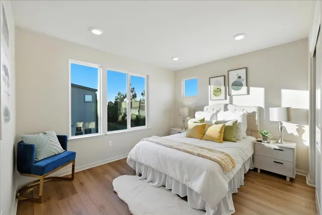 a bedroom with a bed and wooden floor