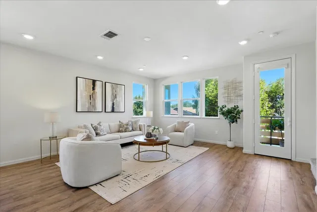 a living room with furniture and wooden floor