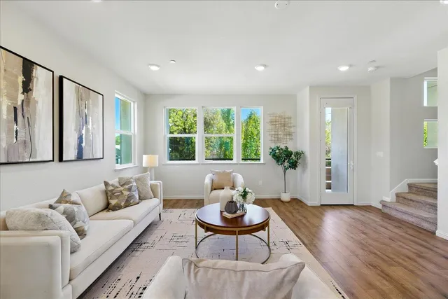 a living room with furniture and wooden floor