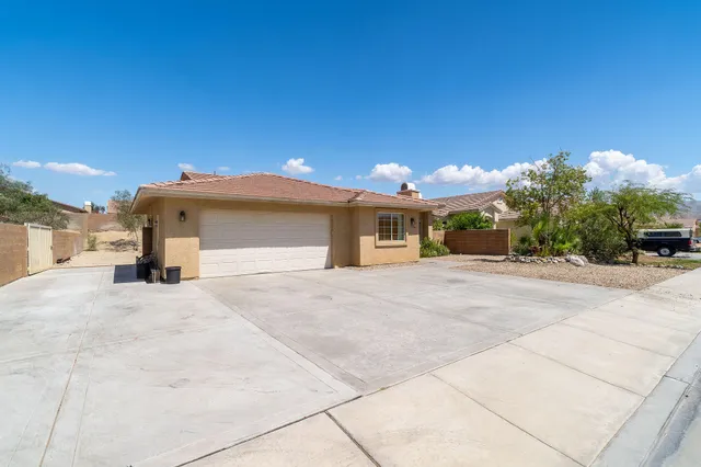 a front view of a house with a yard and a garage
