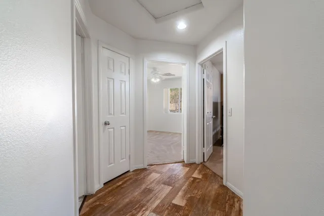 a bathroom with a granite countertop sink a toilet a mirror and shower curtain