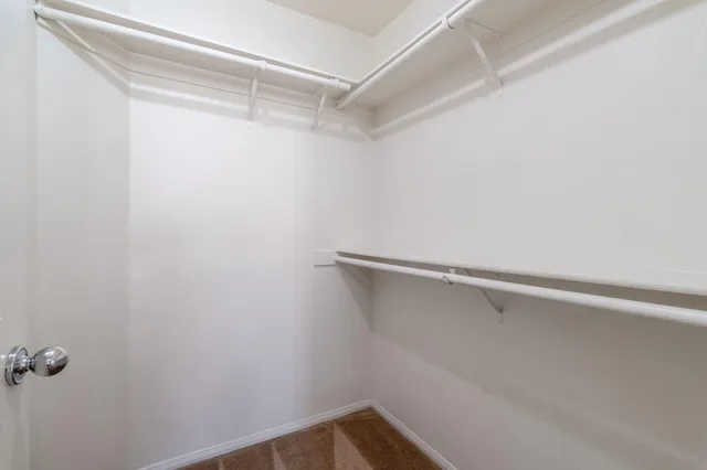 a view of a room with windows and ceiling fan