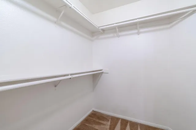 a large kitchen with cabinets table and chairs