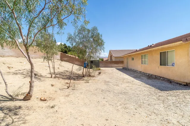 an aerial view of a house with a yard basket ball court and outdoor seating