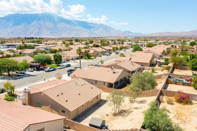 an aerial view of a house with a big yard