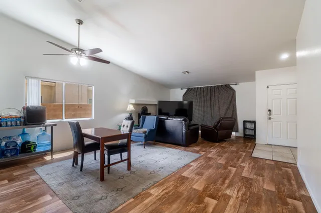 a living room with furniture a ceiling fan and a rug