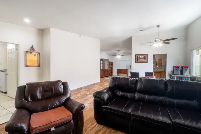 a living room with furniture and a mirror