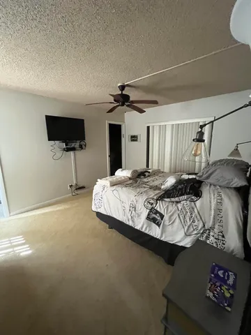 a view of a bedroom with a bed and wooden floor