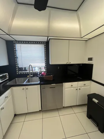 a kitchen with a stove a microwave and furniture