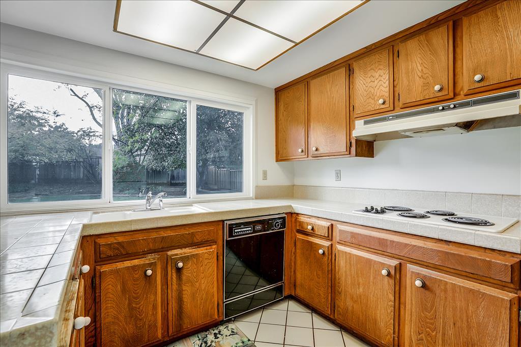 11351 Bubb Road Cupertino, CA 95014 - Photo 12 of 14 a kitchen with a sink stove top oven and cabinets