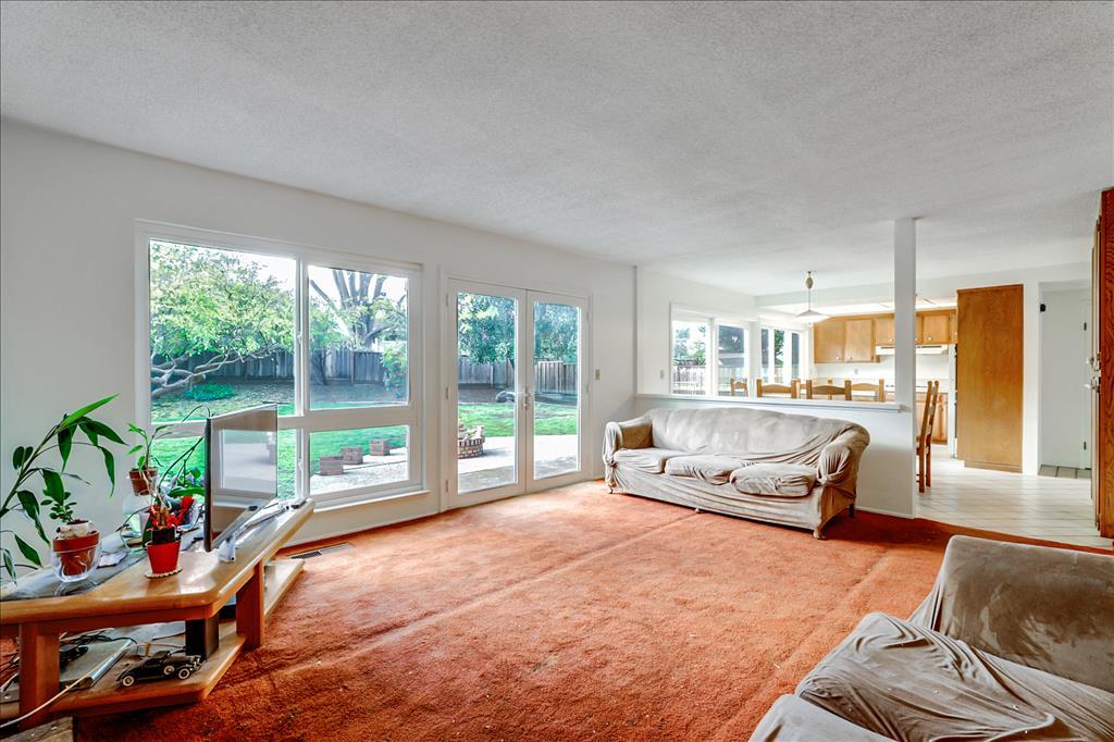 11351 Bubb Road Cupertino, CA 95014 - Photo 7 of 14 a living room with furniture and a floor to ceiling window