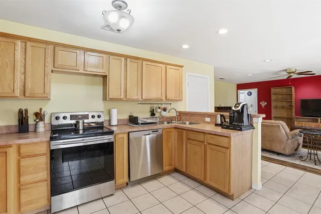 a kitchen with a stove top oven sink and cabinets