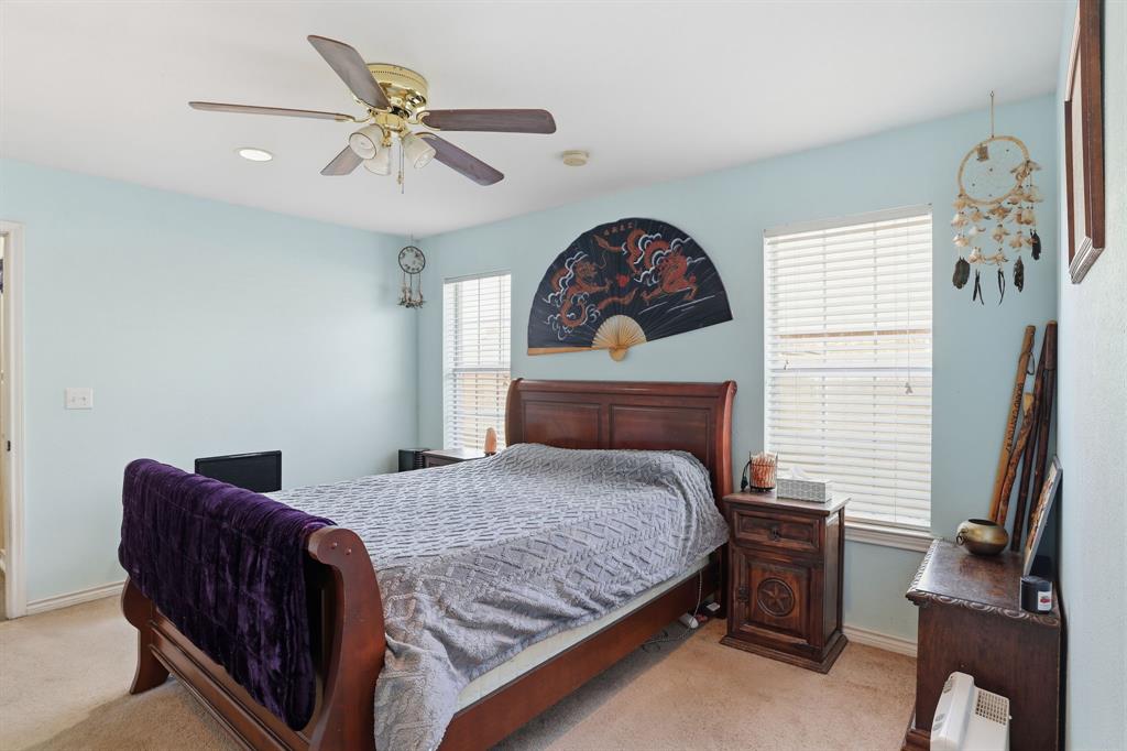 921 Calder Street Howe, TX 75459 - Photo 15 of 25 a bedroom with a bed and a chandelier