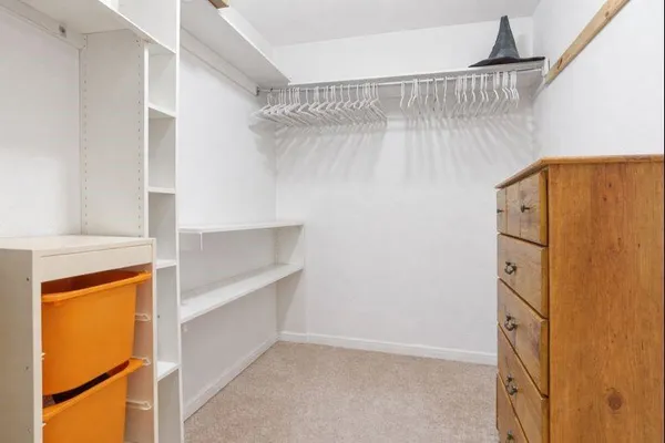 a view of walk in closet with empty racks