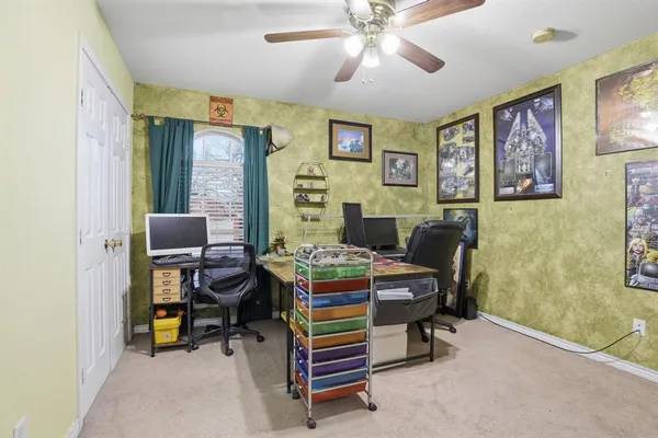 a living room with furniture and a baby crib