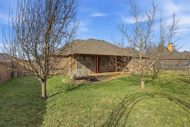 a backyard of a house with table and chairs