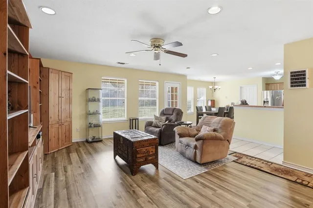 a living room with furniture windows and wooden floor