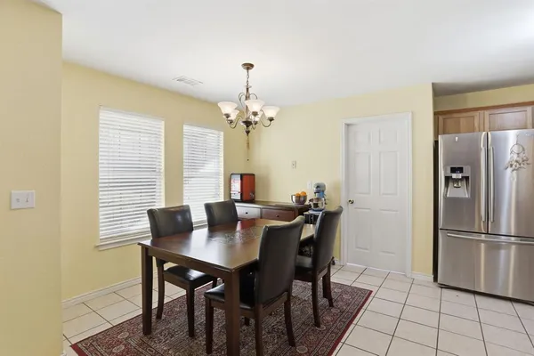 a view of a dining room with a table and chairs