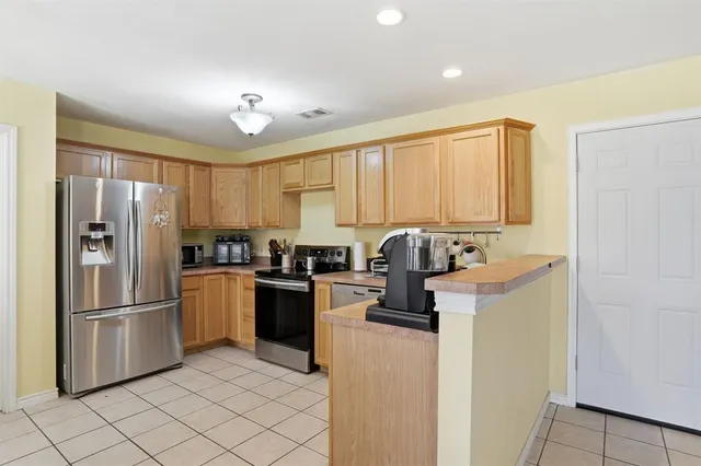 a kitchen with a refrigerator and a sink