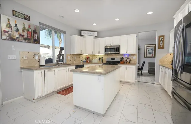 a kitchen with cabinets and window