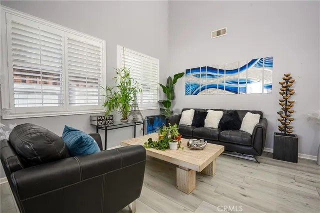 a living room with furniture and a potted plant