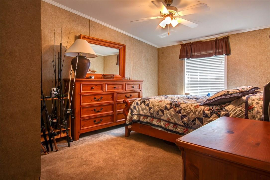 1600 Southwest 65th Avenue Boca Raton, FL 33428 - Photo 16 of 16 a bedroom with a bed and a chandelier