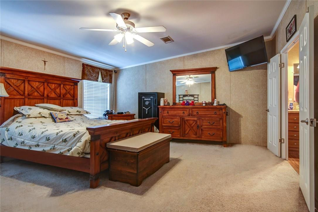 1600 Southwest 65th Avenue Boca Raton, FL 33428 - Photo 8 of 16 a spacious bedroom with a bed a dresser and a chandelier