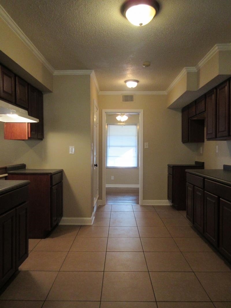 3379 Ridgecrest Street Memphis, TN 38127 - Photo 7 of 8 Kitchen featuring light tile patterned floors, a textured ceiling, visible vents, and crown molding