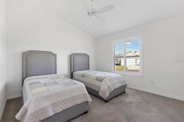 a bedroom with two beds and a window