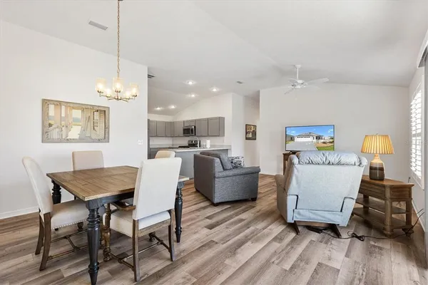 a living room with furniture and kitchen view
