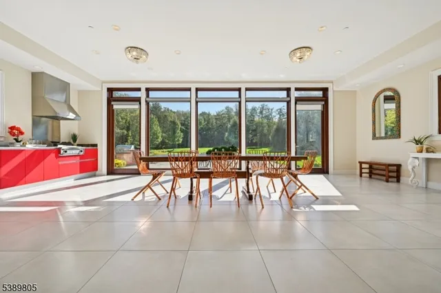 a living room with furniture and large windows