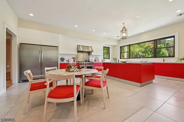 a kitchen with stainless steel appliances granite countertop a stove a sink dishwasher and a refrigerator