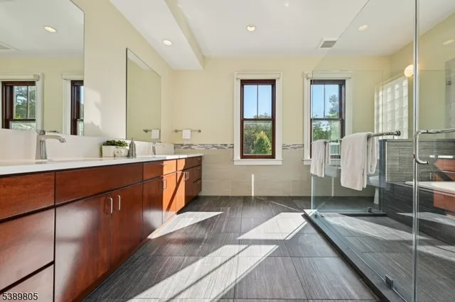 a large bathroom with double vanity and a large mirror