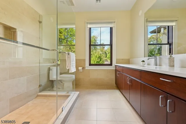 a spacious bedroom with a large bed and a large window