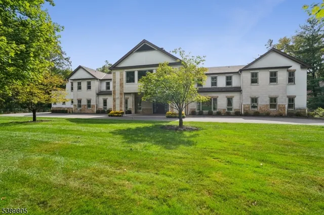 a front view of a house with a yard table and trees