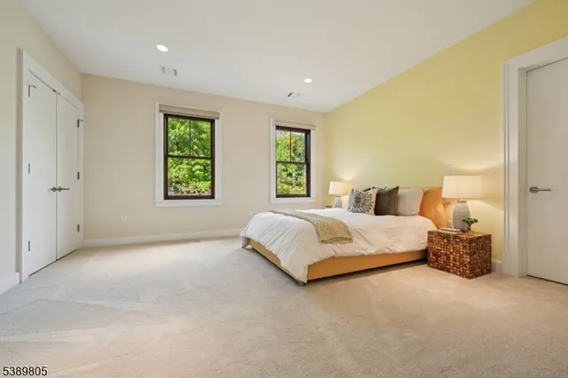 a spacious bedroom with a bed and a window