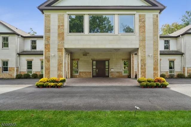 a front view of a house with a garden